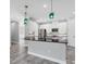Bright kitchen featuring white cabinets, a black countertop island, and stylish hanging pendant lights at 6125 Anise Dr, Sarasota, FL 34238