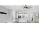 Open living area with view of the kitchen and backyard, enhanced by modern lighting at 6125 Anise Dr, Sarasota, FL 34238