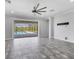 Spacious living room with tile flooring and a view of the outdoor pool area at 6125 Anise Dr, Sarasota, FL 34238