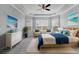 Serene main bedroom features bay windows, coastal decor, and a tray ceiling at 6125 Anise Dr, Sarasota, FL 34238