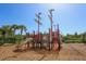 Outdoor playground featuring pirate ship theme on a mulch ground covering and views of palm trees and sunny skies at 6125 Anise Dr, Sarasota, FL 34238