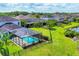Home with a screened pool, lush greenery, and privacy fencing, creating a serene backyard oasis at 6125 Anise Dr, Sarasota, FL 34238