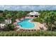 Aerial view of the resort style pool, lounge chairs, pool house and tropical landscaping at 6125 Anise Dr, Sarasota, FL 34238