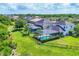 Aerial view of homes with backyard screened pools and fenced yards in a lush, green community at 6125 Anise Dr, Sarasota, FL 34238