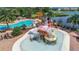 This is a community pool with a kid-friendly pirate ship water park feature and lounge chairs for relaxing by the water at 6125 Anise Dr, Sarasota, FL 34238