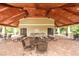 Covered poolside pavilion with tables, chairs, and an outdoor grill for community gatherings at 6125 Anise Dr, Sarasota, FL 34238