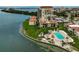 An aerial view shows condo buildings with a pool and nearby waterway at 6372 Palma Del Mar S Blvd # 503, St Petersburg, FL 33715