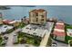 An aerial view shows condo buildings with parking, landscaping and water nearby at 6372 Palma Del Mar S Blvd # 503, St Petersburg, FL 33715
