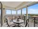 Enclosed balcony with chairs, table, and water view at 6372 Palma Del Mar S Blvd # 503, St Petersburg, FL 33715