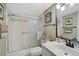 Bright bathroom featuring a shower and tub combination with decorative sliding doors and a sleek, modern vanity at 6372 Palma Del Mar S Blvd # 503, St Petersburg, FL 33715