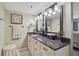 Modern bathroom with double mirrors and vanity with black hardware, plus granite countertops and modern lighting at 6372 Palma Del Mar S Blvd # 503, St Petersburg, FL 33715