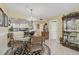 Bright dining room with modern chandelier and views into the kitchen at 6372 Palma Del Mar S Blvd # 503, St Petersburg, FL 33715
