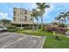 Condo building with covered parking, tropical landscaping, and a fire hydrant at 6372 Palma Del Mar S Blvd # 503, St Petersburg, FL 33715