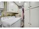 This laundry room features white appliances, cabinetry and plentiful storage space at 6372 Palma Del Mar S Blvd # 503, St Petersburg, FL 33715
