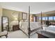 Spacious bedroom featuring a four-poster bed with view to the outside balcony with seating arrangement at 6372 Palma Del Mar S Blvd # 503, St Petersburg, FL 33715