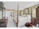 Large bedroom features a carpeted floor, a door to the balcony, and is decorated with wooden antique furniture at 6372 Palma Del Mar S Blvd # 503, St Petersburg, FL 33715