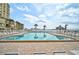 Inviting swimming pool with lounge chairs and palm trees at 6372 Palma Del Mar S Blvd # 503, St Petersburg, FL 33715