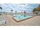 Relaxing swimming pool with a triangular shape surrounded by lounge chairs at 6372 Palma Del Mar S Blvd # 503, St Petersburg, FL 33715