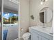 Bathroom featuring light blue vanity with a view of the pool at 6643 Butlers Crest Dr, Bradenton, FL 34203