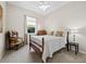 Cozy bedroom with wood-frame bed, neutral decor, and natural light at 6643 Butlers Crest Dr, Bradenton, FL 34203