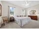 Spacious bedroom with two windows, dresser, and a bed with decorative pillows at 6643 Butlers Crest Dr, Bradenton, FL 34203