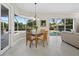 Breakfast nook with a glass-topped table, bay windows, and a view of the pool area at 6643 Butlers Crest Dr, Bradenton, FL 34203