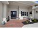 Welcoming front porch with brick flooring, a decorative fountain, and a charming seating area at 6643 Butlers Crest Dr, Bradenton, FL 34203