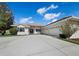 Charming home featuring a well-manicured lawn and a long driveway leading to the attached garage at 6643 Butlers Crest Dr, Bradenton, FL 34203