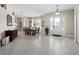 Grand foyer with tile flooring, chandelier, and an elegant entry door, leading to a formal dining area at 6643 Butlers Crest Dr, Bradenton, FL 34203