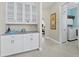Hallway with built-in cabinets, marble countertop, and access to laundry room at 6643 Butlers Crest Dr, Bradenton, FL 34203