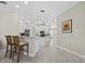 Bright kitchen featuring white cabinetry, granite countertops, and a breakfast bar with seating at 6643 Butlers Crest Dr, Bradenton, FL 34203
