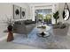 Bright living room with stylish gray sofa, matching armchairs, and elegant decor at 6643 Butlers Crest Dr, Bradenton, FL 34203