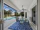 Inviting screened patio features a ceiling fan and a dining area overlooking the sparkling pool at 6643 Butlers Crest Dr, Bradenton, FL 34203