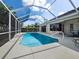 Swimming pool with a screened-in enclosure, spacious deck, and landscaped surroundings at 6643 Butlers Crest Dr, Bradenton, FL 34203