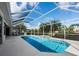 Backyard screened-in pool and lanai with lush landscaping and relaxing atmosphere at 6643 Butlers Crest Dr, Bradenton, FL 34203