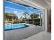 Screened in pool and patio with tropical landscaping at 6643 Butlers Crest Dr, Bradenton, FL 34203