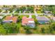 An aerial view shows a community of beautiful houses, green lawns, and private pools at 7804 Broadmoor Pines Blvd, Sarasota, FL 34243