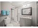 Clean bathroom featuring a modern vanity, decorative towels, and a beach-themed painting at 7804 Broadmoor Pines Blvd, Sarasota, FL 34243