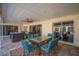 Covered outdoor patio area featuring dining and relaxing spaces, ideal for entertaining guests at 7804 Broadmoor Pines Blvd, Sarasota, FL 34243