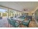 Outdoor patio with table seating and lounge area overlooking sparkling pool at 7804 Broadmoor Pines Blvd, Sarasota, FL 34243