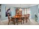 Elegant dining room features a chandelier, hutch, and a large painting on the wall at 7804 Broadmoor Pines Blvd, Sarasota, FL 34243