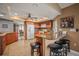Large kitchen with granite countertops, tile floors, and a bar with seating at 7804 Broadmoor Pines Blvd, Sarasota, FL 34243