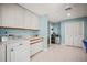 Bright laundry room with white appliances, ample storage and built-in sink near folding counter at 7804 Broadmoor Pines Blvd, Sarasota, FL 34243