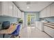Spacious laundry room with washer, dryer, and ample storage cabinets, and granite countertop desk at 7804 Broadmoor Pines Blvd, Sarasota, FL 34243