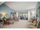 Bright living room with vaulted ceiling, tile flooring, and sliding doors leading to the lanai at 7804 Broadmoor Pines Blvd, Sarasota, FL 34243