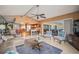 Bright living room with vaulted ceiling, tile flooring, and an open layout to the kitchen at 7804 Broadmoor Pines Blvd, Sarasota, FL 34243