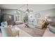 Comfortable living room with vaulted ceiling, tile flooring, and an abundance of natural light at 7804 Broadmoor Pines Blvd, Sarasota, FL 34243