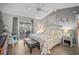 Serene main bedroom featuring a sliding glass door to the backyard, light wood floors, and a decorative coastal design at 7804 Broadmoor Pines Blvd, Sarasota, FL 34243