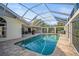 Relaxing backyard pool with screened enclosure, paved deck, and cozy outdoor seating at 7804 Broadmoor Pines Blvd, Sarasota, FL 34243