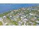 Aerial view of the neighborhood homes near the bay and a marina in a waterfront community at 7913 19Th Avenue W Dr, Bradenton, FL 34209